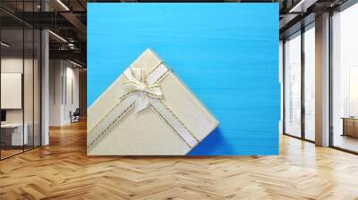 Gift boxes on a blue wooden background and copy space. Wall mural