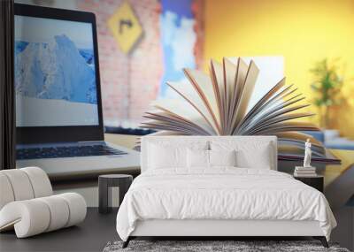 open books and laptop on the table. close-up of a fanned book Wall mural