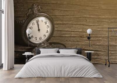 luxury vintage black pocket watch on wooden table, abstract for time concept with copy space, sepia effect Wall mural