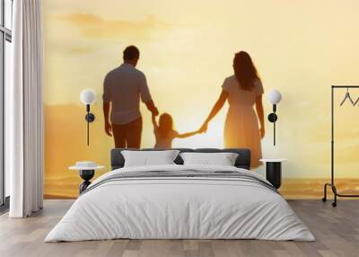 A family walks hand in hand along a beach at sunset, creating cherished moments filled with love and happiness. Wall mural