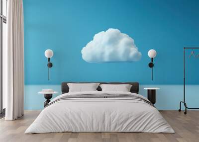 A fluffy cloud floats peacefully against a vibrant blue background, creating a serene and calming atmosphere in the image. Wall mural