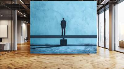 A solitary man in a suit stands balanced on a beam in a minimalist blue space, embodying concepts of balance, stability, and solitude. Wall mural