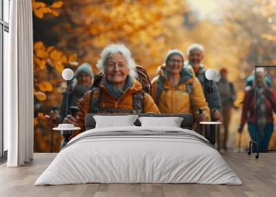 Senior woman hiking through autumn forest Wall mural