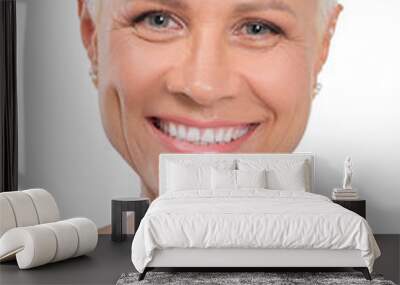 Closeup portrait of senior lady with healthy skin and bright smile isolated on white Wall mural