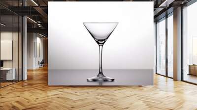 Elegant gin cocktail glass placed at the center of a plain and simple surface creating a minimalist and modern still life composition that showcases the drink s clarity transparency Wall mural