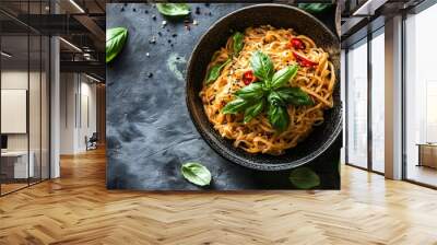 Steaming hot and aromatic noodle dish garnished with fresh green basil and vibrant red chili peppers ready to be enjoyed as a delicious and flavorful meal Wall mural