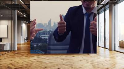 a group of happy businesspeople clapping hands and thumbs up expresses happiness and success. Wall mural