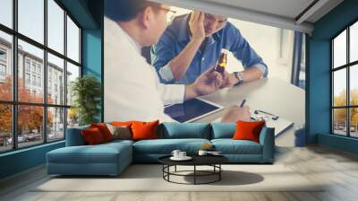 The doctor is explaining the medication to the patient. Wall mural