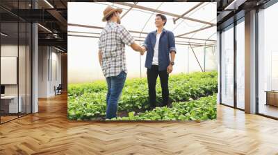 The young farmers shake hands to congratulate the customers after the negotiations business are successful. Wall mural