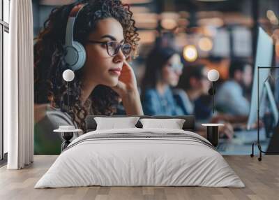 A woman wearing headphones is sitting at a desk with other people, Generative AI Wall mural