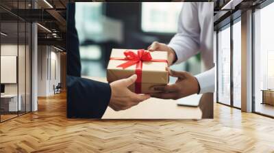 Close up view of hands Giving a business gift in an office. Wall mural