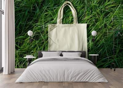 Mockup of a white tote bag laying on grass, White cotton or mesh eco bag on green grass Wall mural