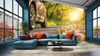 summer car tires in the blooming spring in the sun, time for summer tires Wall mural