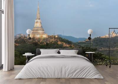 White pagoda illuminated on hill at sunset Wall mural