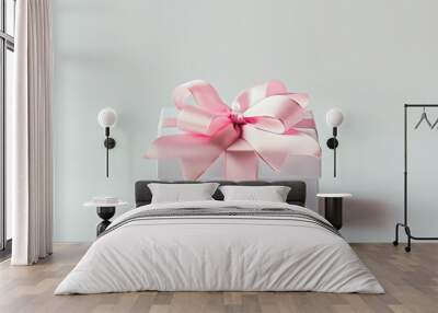 Elegant white gift box with a pink ribbon, isolated on a gray background, perfect for celebrations and special occasions. Wall mural