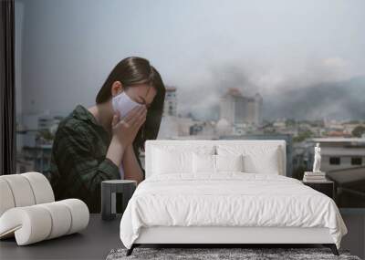 Woman coughing.Woman wearing face mask because of air pollution in the city Wall mural