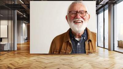 A smiling older man with glasses and a beard, wearing a casual jacket, against a neutral background. Wall mural