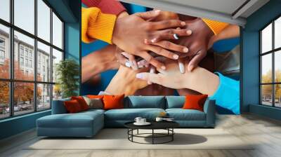 workforce diversity in the workplace a group of people, including a person wearing a blue shirt and another wearing a white shirt, stand together with their hands visible one person's hand is Wall mural