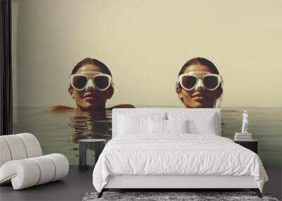 Dual swimmers wear goggles in minimalist ocean setting under soft light Wall mural