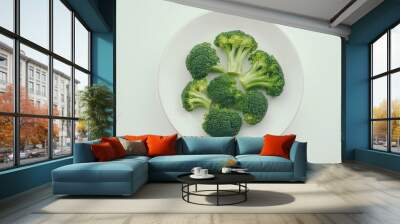 Fresh broccoli florets on white plate: minimalist green cuisine Wall mural