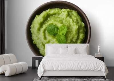 Fresh green avocado dip with mint leaves in rustic brown bowl on white background Wall mural