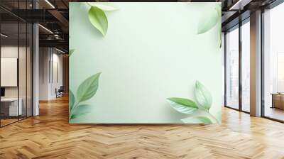 Fresh green leaves on soft pastel background for natural and eco-friendly designs Wall mural