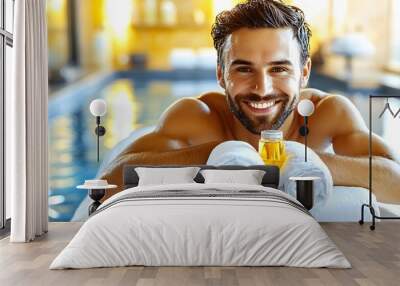 Relaxed man at spa with towel and oil by poolside Wall mural