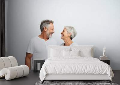 senior couple laughing together on white background copy space  Wall mural