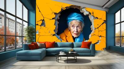 An intrigued elderly woman peeping out from a torn yellow wall, full of surprises, card with copy space,  Wall mural