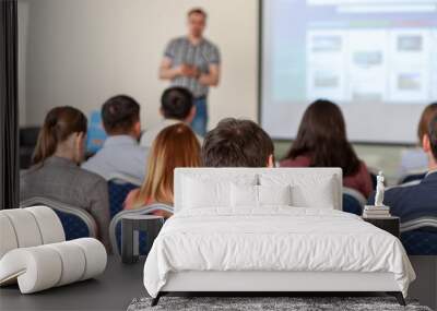 Spectators listen to the speech in the conference room. The focus is under the person on the front surface Wall mural