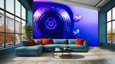 .Camera lens with purple and blue backlight. Optics Wall mural