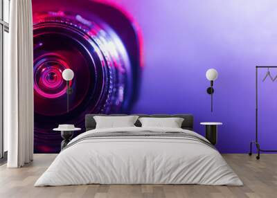 Camera lens with purple and pink backlight. Optics Wall mural