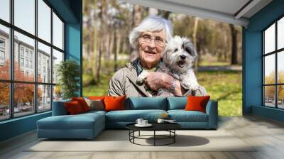 Beautiful Happy Senior Woman Hugging her Cute Dog Outdoor Wall mural