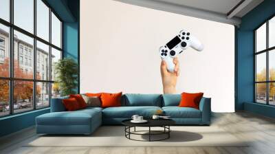 White video game joystick in hand on clean background. Wall mural