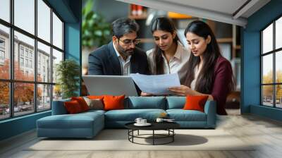 Indian young businesspeople using laptop in group meeting at desk
 Wall mural