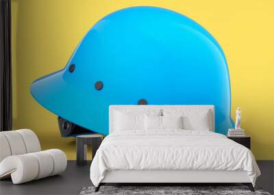 Blue safety helmet or hard cap isolated on yellow background Wall mural