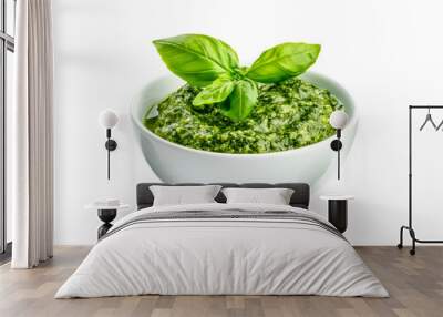 Ceramic bowl of fresh green pesto sauce with basil leaves isolated on a white transparent background. Concept of homemade food and healthy eating Wall mural