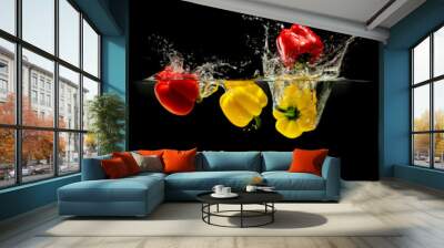 Group of bell pepper falling in water with splash on black background Wall mural