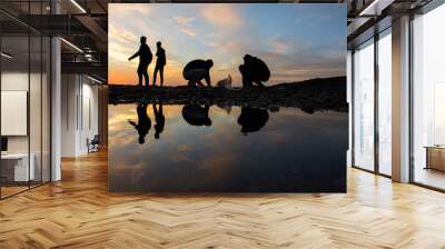 People reflection in pond walking on sandy beach mediterranean sea, landscape beautiful evening sky, sunset sea beach with silhouettes of man walking in jijel  Algeria Africa, young men, coast shore. Wall mural