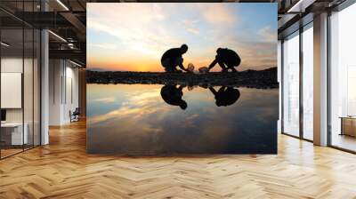 People reflection in pond walking on sandy beach mediterranean sea, landscape beautiful evening sky, sunset sea beach with silhouettes of man walking in jijel  Algeria Africa, young men, coast shore. Wall mural