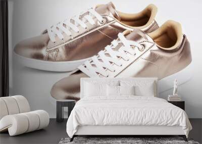 Gold shiny sneakers on white background.  Wall mural