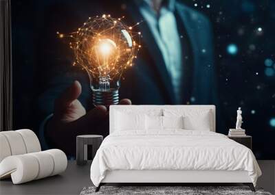 A businessman holds a light bulb, representing digital innovation technology, smart home integration, and an AI icon network connection  Wall mural