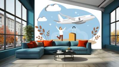 The concept of traveling and flying by plane. The woman is happy about the vacation. Yellow suitcase Wall mural