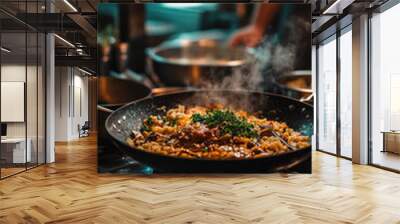 A man is cooking food in a pan with a lot of steam coming out of it. The food is a stir fry with vegetables and meat Wall mural