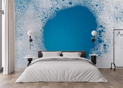 Detergent foam bubble on water. Blue background, Soap sud Wall mural