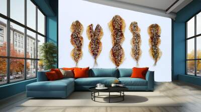 Dried fish with sesame seeds on white background. Wall mural