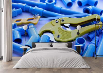 Plumber equipment with blue pvc pipe connections for plumbing work. Wall mural