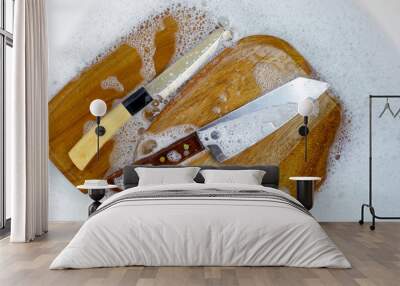 Wooden cutting board in foam of dishwashing liquid. Wall mural