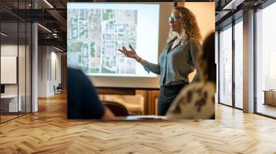 A female urban planner presenting a new development project to the city council. She’s using a projector to show plans Wall mural