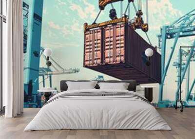 An operator in a crane hoists a large container at a port facility. The scene shows cargo operations Wall mural